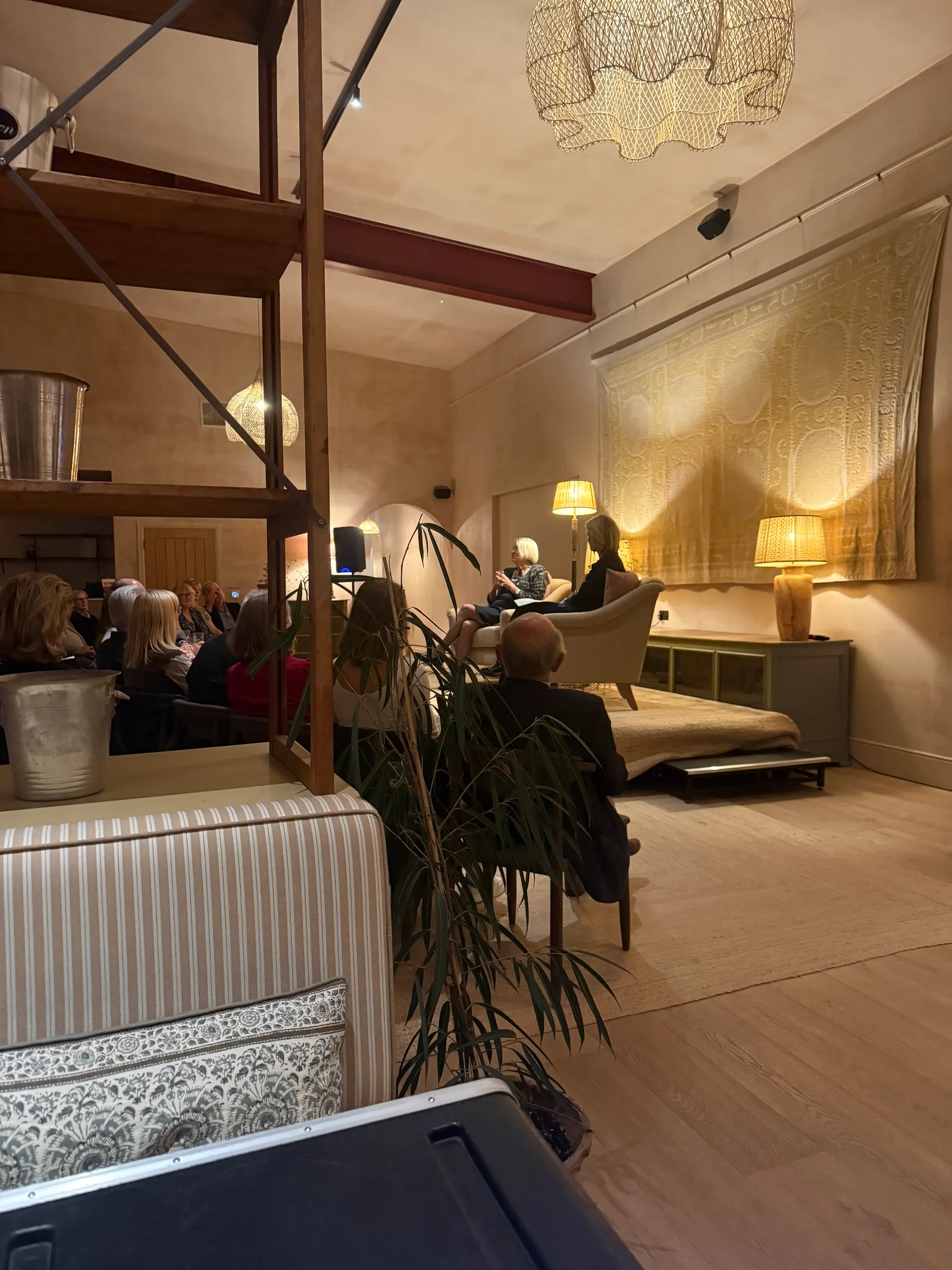 The conversation between Kate Adie and Lady Edwina Grosvenor underway at Barnsgrove, viewed from the side of the room