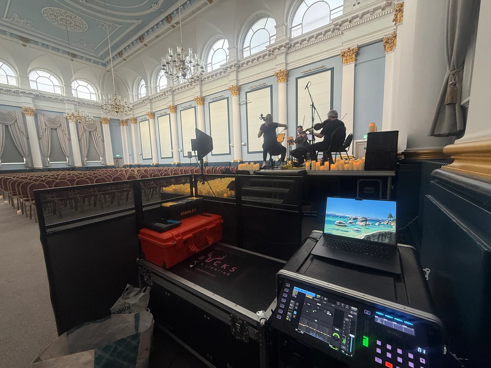 The sound-control position beside the stage at Rochester Corn Exchange, with the quartet rehearsing in the background
