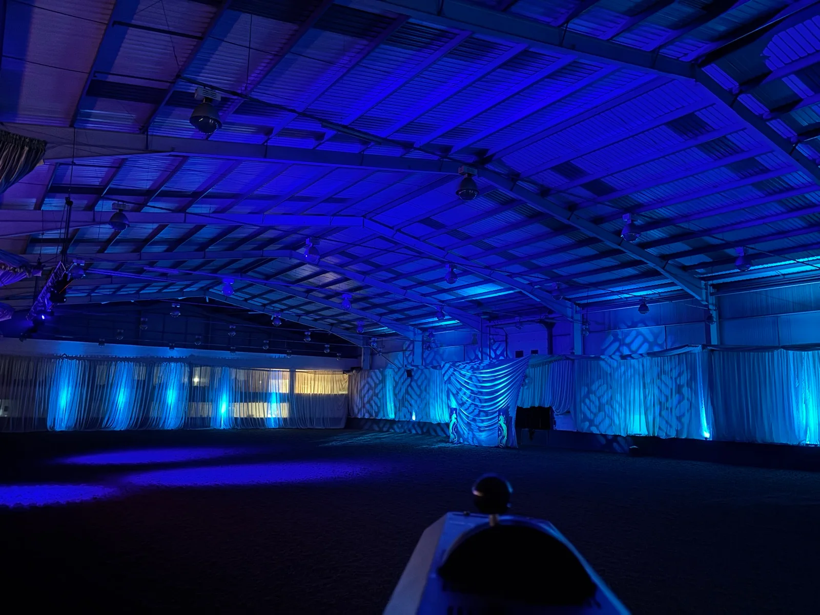 Blue and turquoise lighting across the indoor arena at Horsemanship in September 2026